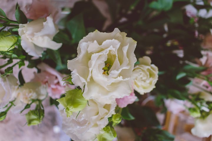 A close-up of an elegant white ruffled flower in a luxury bouquet from Grace & Blooms, a florist offering flower delivery in Naples, FL.